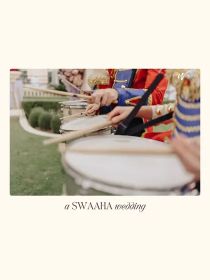 The roll of the drums signals the start of the baraat. This close-up captures the hands of the marching band, building anticipation.