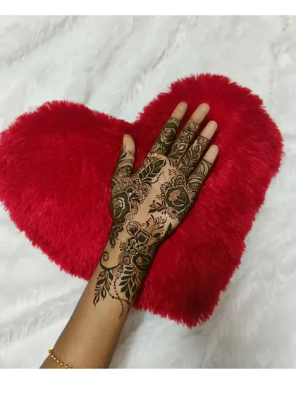 A delicate floral and vine pattern on the back of the hand. This is a great example of a simple yet elegant party henna design.