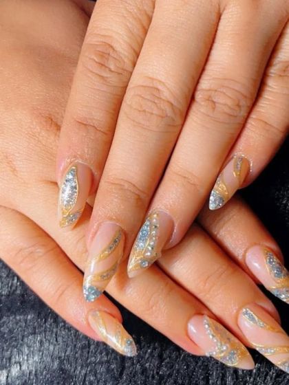 Another angle of these glamorous gold and silver glitter bridal nails. The sharp almond shape of the extensions elongates the fingers, while the sparkling design catches the light beautifully.