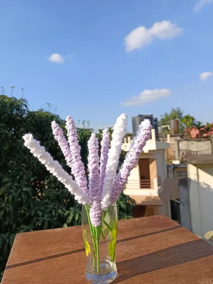 A vase of lavender stems in white and lilac.
