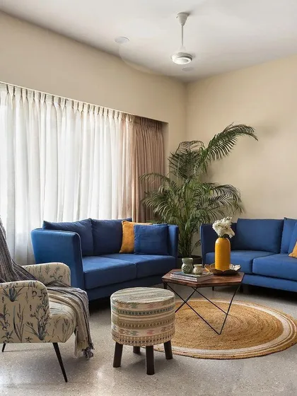 A perfect example of a comfortable and chic living room. We paired bold blue sofas with neutral walls and a jute rug to create a space that feels both vibrant and grounded, with plenty of natural light.