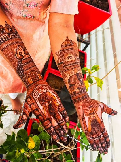 A beautiful design featuring elephants on the palms and intricate patterns extending up the arms.