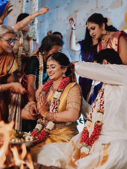 A collection of moments from bride Ishwarya's Muhurtham. Her golden wedding saree was draped to be both photogenic and practical for the various ceremonies of a traditional South Indian wedding.