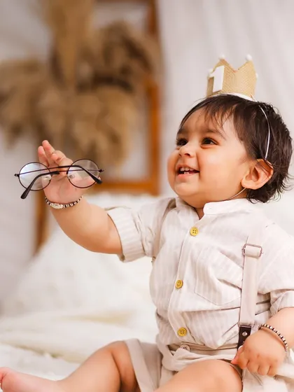 A playful moment with a pair of glasses. I love incorporating simple props that bring out your baby's personality and lead to adorable, unexpected photos.