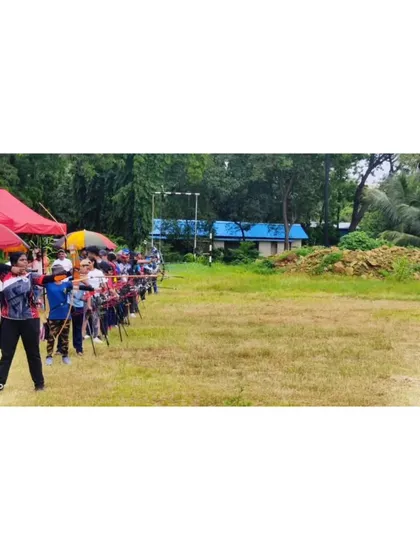 A wide view of the shooting line at the regional competition, with archers of all ages participating under the watchful eyes of coaches and officials.