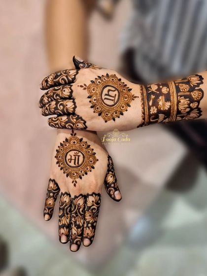 A simple yet meaningful back-hand design for a baby shower. This piece features "Maa" (mother) and "Paa" (father) initials inside beautiful mandalas, surrounded by delicate lotus patterns.