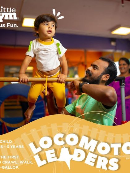 With a parent's guidance, this toddler is taking his first steps in gymnastics. Balancing on the bar helps develop core strength and confidence, laying the groundwork for more advanced locomotor skills like walking and running.
