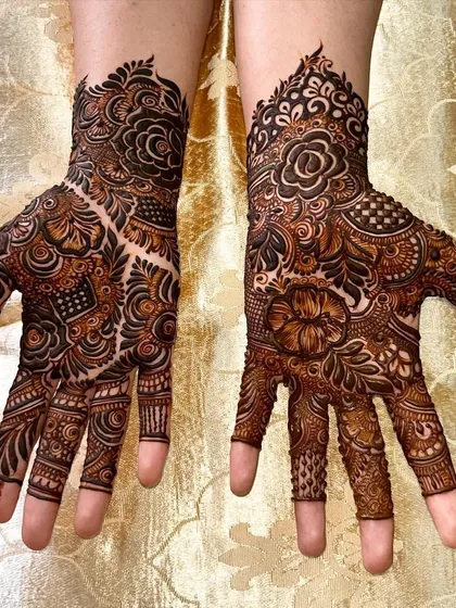 A rich and detailed design combining roses, paisleys, and geometric fillers for a classic bridal look.