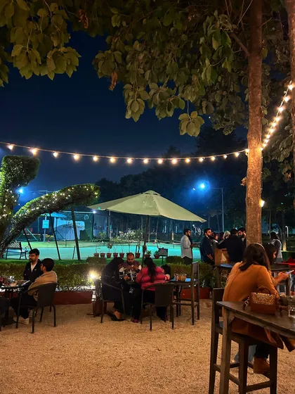 The cafe patio comes alive at night with string lights, creating a magical ambiance for dinner and drinks.