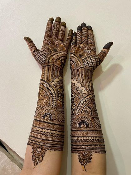 Full bridal mehendi from fingertips to elbows. This design is a beautiful example of traditional Indian henna artistry.