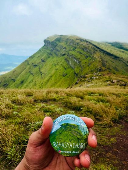 Our "Chikmagalur" badge held against one of the region's iconic peaks. A great souvenir from an amazing trip.