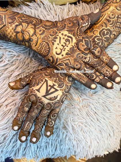 A close-up of personalized palms, featuring the initials 'N' and 'Z' and a name in Arabic script.