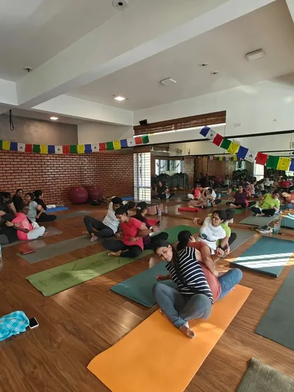 A seated twist in a partner setting. By sitting back-to-back, we can use each other for leverage to deepen the spinal twist, enhancing its detoxifying benefits.