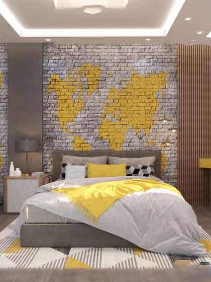 An industrial-chic room for a travel enthusiast, featuring a world map mural on a brick accent wall. The bold yellow accents in the bedding and desk create a vibrant, energetic space.