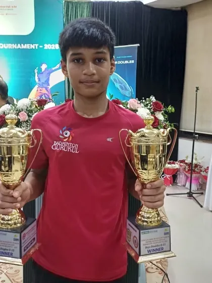 Mayuresh Bhutki holding his two winner's trophies from the Yonex-Sunrise Ramsheth Thakur Trophy Konkan Region Badminton Tournament.