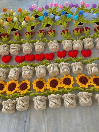 An overhead view of a large order, featuring rows of potted sunflowers and heart-shaped flowers.