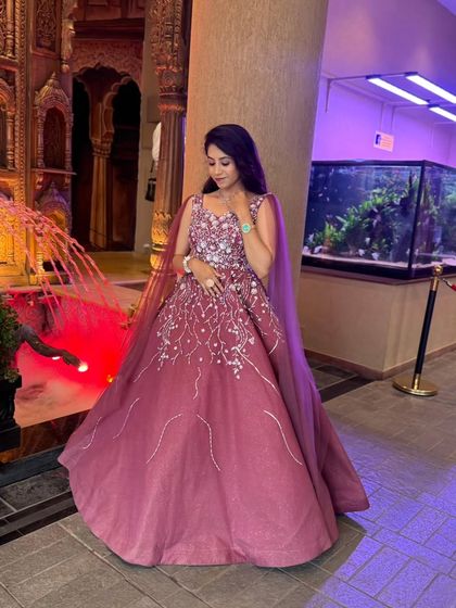 A full-length view of this elegant wine-colored gown. The cape detail adds a touch of royalty, perfect for a grand entrance at your reception.