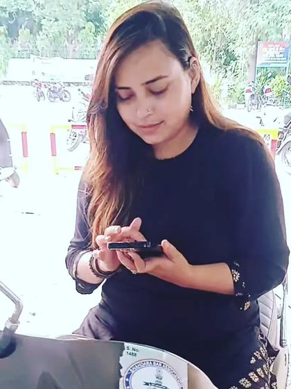 A casual moment on a scooter, checking my phone. It shows a relatable, everyday side of my life outside the formal court setting.
