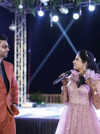 A candid moment of interaction with the bride on stage during her Sangeet. Listening to her is just as important as speaking.
