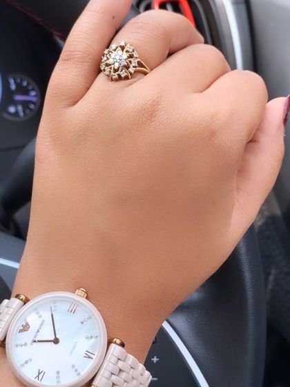 A detail shot of the accessories for a lunch date. A classic watch and a statement ring add a touch of sophistication and personal style.
