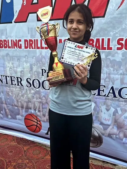 A player with her runner-up trophy. We teach our players to value the effort and learn from every game, win or lose.
