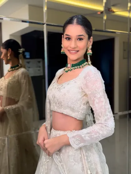 Showcasing modern elegance with this stunning bride in a white lehenga. This look proves that bridal beauty comes in every color, with a focus on fresh, glowing skin and sophisticated styling.
