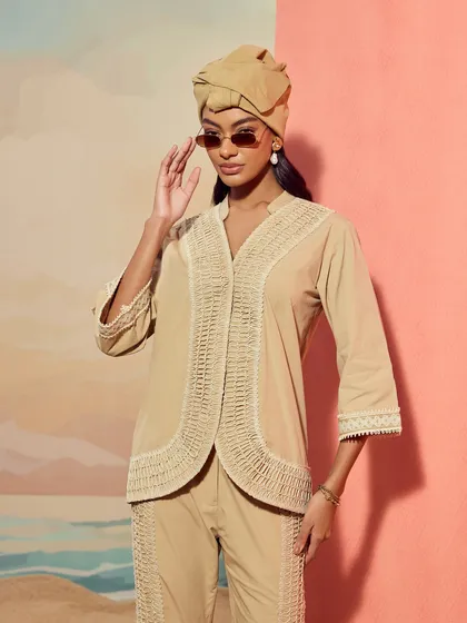 A closer portrait of the Qala Clothing co-ord set, focusing on the intricate lace detailing along the shirt's placket.