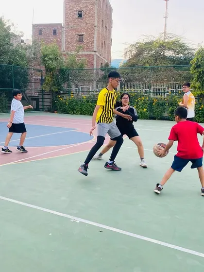 A young player practices his dribbling moves against a defender.