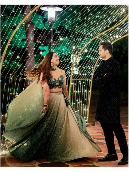 A magical twirl under a tunnel of fairy lights. We use creative lighting to make your Sangeet and Cocktail party photos look enchanting.