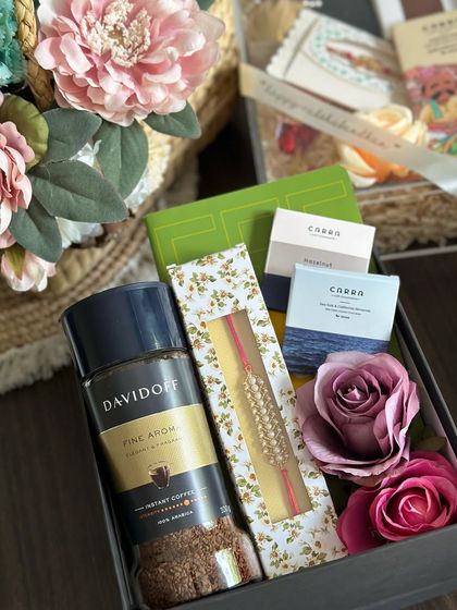 A classic Rakhi gift for the coffee lover. This hamper includes Davidoff coffee, Carra mini chocolate bars, a diary, and a beautiful rakhi, presented in a simple yet elegant box.