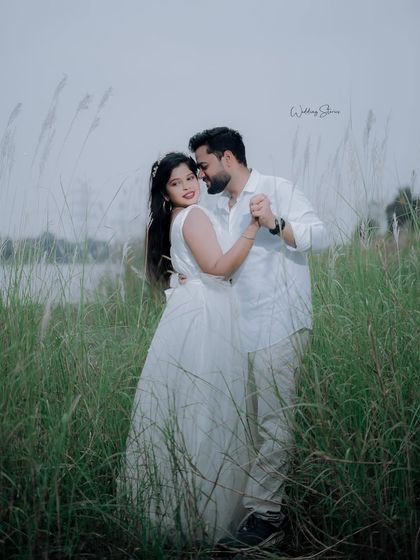 A graceful dance pose in the middle of a green field. This shot is elegant, romantic, and showcases the beautiful natural surroundings.