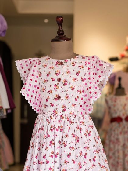 Another look at this charming floral and polka dot dress. The scalloped flutter sleeves and button details make it a truly special piece in my collection.
