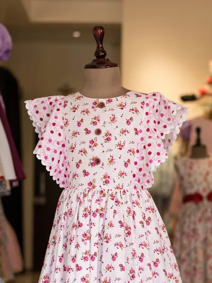 Another look at this charming floral and polka dot dress. The scalloped flutter sleeves and button details make it a truly special piece in my collection.