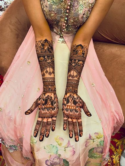 Here, the palms feature beautiful bride and groom figures, each surrounded by traditional patterns. This style of portrait mehndi is a popular choice for brides who want their henna to be a centerpiece of their look.