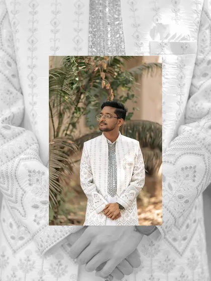 A stylish portrait of the groom, framed within a larger image of his intricate sherwani. A creative shot that highlights the details of the day.