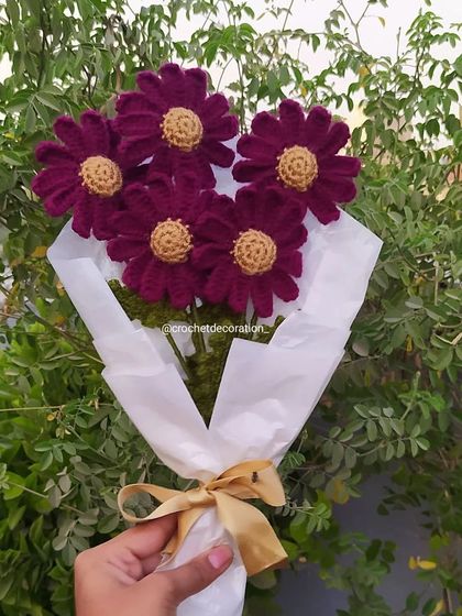 A simple yet elegant bouquet of five deep magenta crochet daisies. This piece highlights the rich color possibilities and the detailed stitching of each flower head.