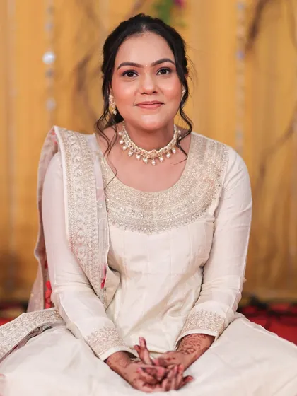 A seated portrait of the guest, looking serene and beautiful with a soft smile.