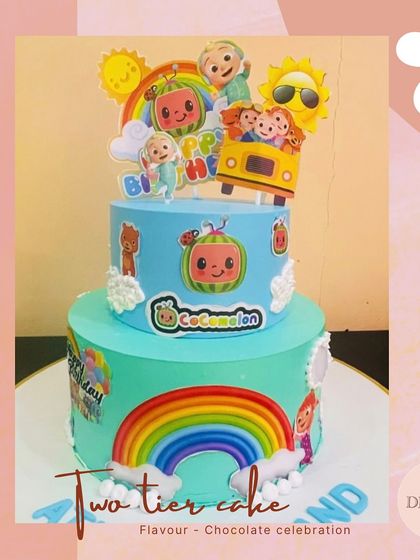 A vibrant two-tier Cocomelon themed cake, perfect for a toddler's birthday. The cake features edible images of the popular characters and a bright rainbow.