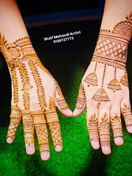 A clear, top-down view of the jhumka and vine designs, showing the clean application.