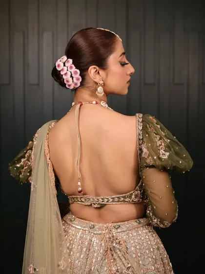 Twisted and entangled with elegance. For this bridal look, I created a clean, sophisticated bun and adorned it with a line of delicate pink flowers for a modern touch.