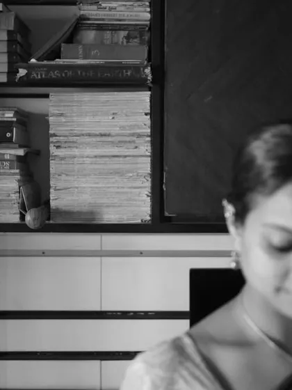 A candid, thoughtful moment. The shallow depth of field and B&W treatment create a poetic and introspective mood.