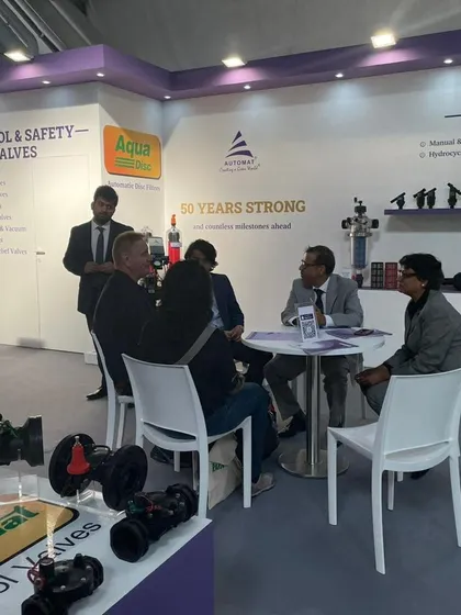 A meeting in progress at our EIMA booth, with our product displays for control valves and filters providing a practical backdrop for the conversation.
