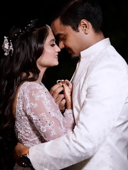 A romantic moment between the couple. The bride's soft glam makeup looks stunning in this intimate close-up shot.