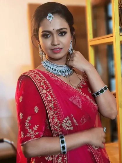 A beautiful client in a red outfit, wearing a simple yet elegant American Diamond choker. This is a great rental option for any party.