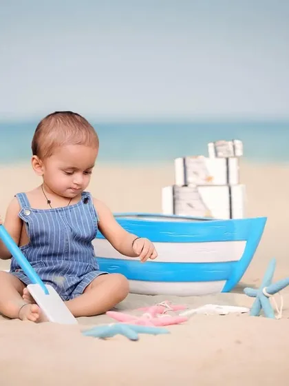 A little explorer digging in the sand. Candid moments of play like this are what make beach photoshoots so special and authentic.