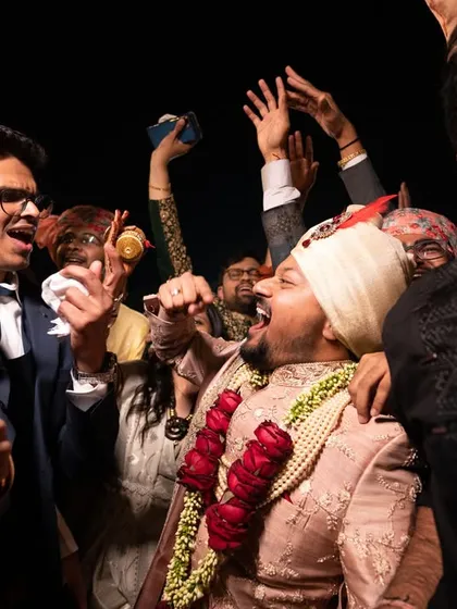 The groom's friends celebrating with him during the baraat, a moment of pure energy.