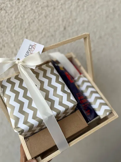 A classy and useful birthday gift in a wooden crate. The items are elegantly wrapped, creating a sense of anticipation and making the employee feel truly special on their day.