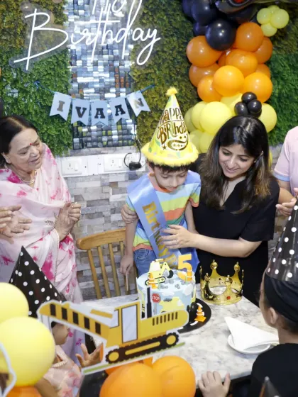 The cake cutting moment at a construction-themed party. I love seeing the joy on everyone's faces.