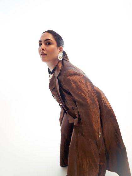 An editorial-style shot of Sakshi, highlighting the sculpted features and the flawless finish of the makeup.