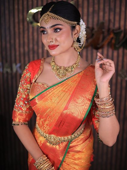 More shots of this gorgeous red and orange Kanchipuram saree. For photoshoots, I ensure every detail, from the pallu to the waist pleats, is absolutely perfect.